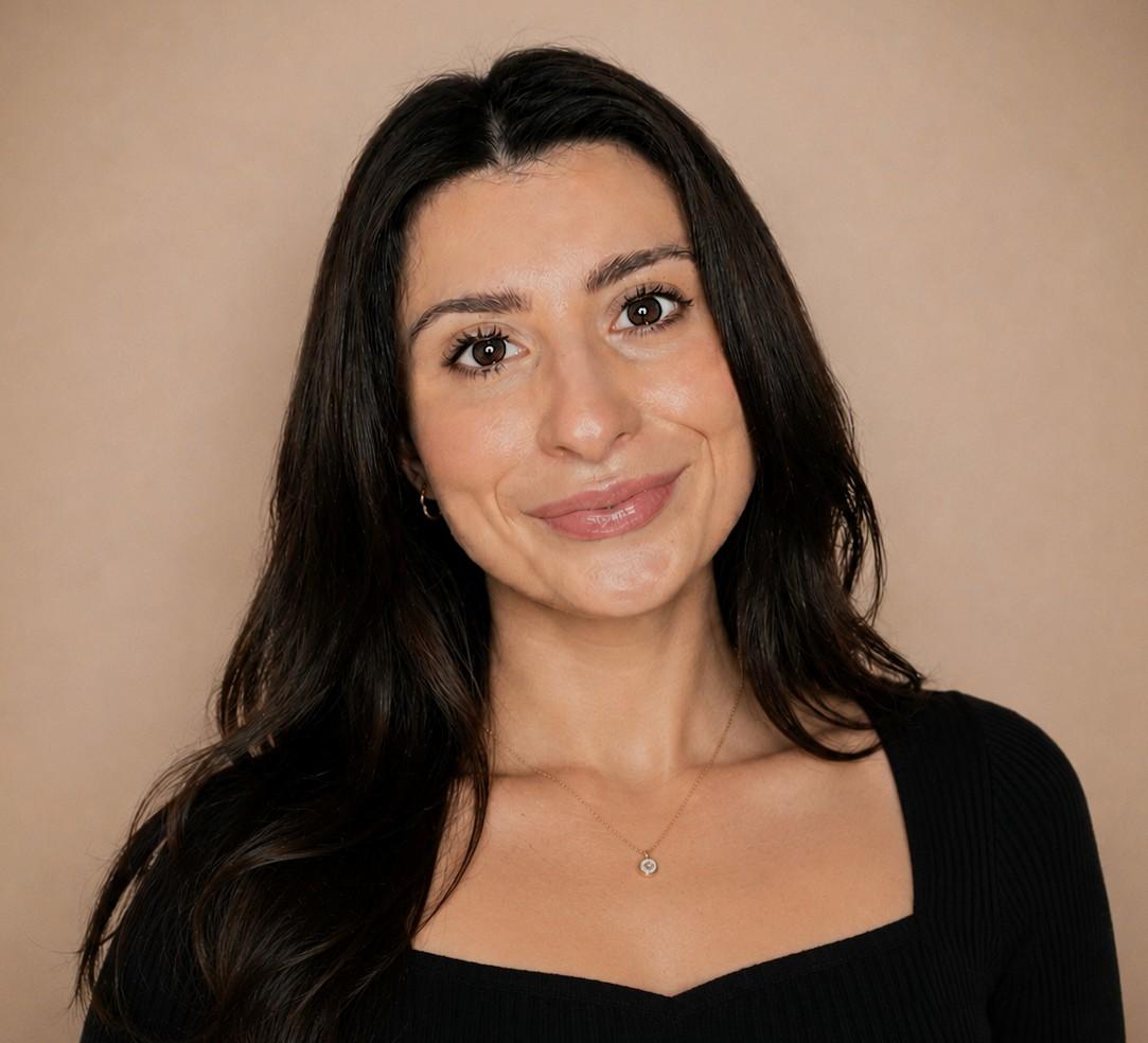 Nicoletta Primo, Lived Experience Policy and Engagement Manager at Sight Scotland. Nicoletta is smiling and has long brown hair.
