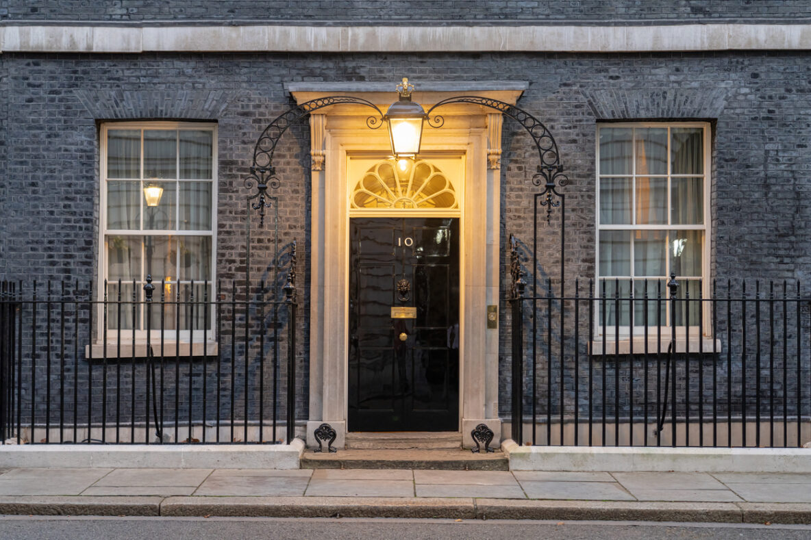 Number 10 Downing Street with a light on over the door
